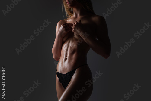 Sexy breast and slim belly. Topless sexy womans body with nude sexy belly. Sensual beauty female belly, slim nude young model undressed in studio. Naked strip female body. Sexy girl.