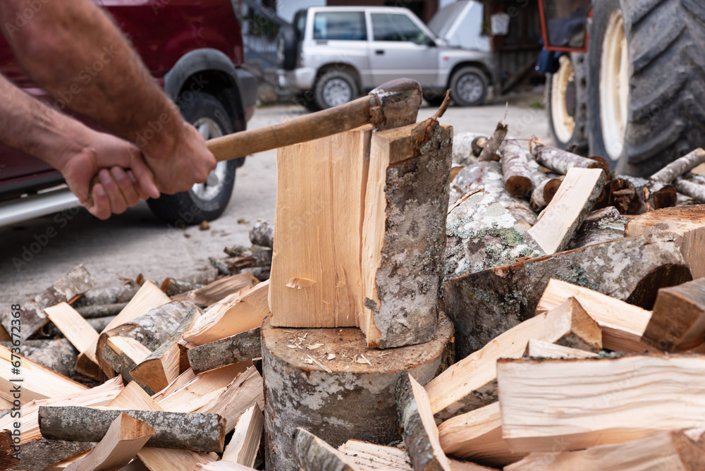 Chopping firewood with an ax preparing for winter Chopping firewood with an ax preparing for winter