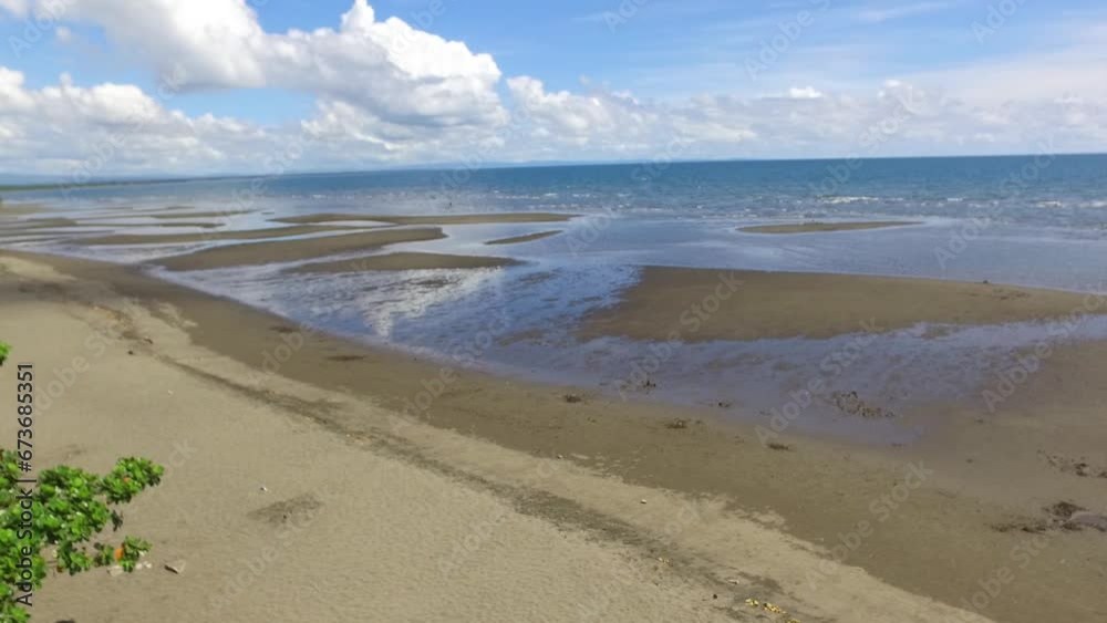 Ocean beach resort at its lowest tide . Drone aerial shot Ocean beach resort at its lowest tide . Drone aerial shot