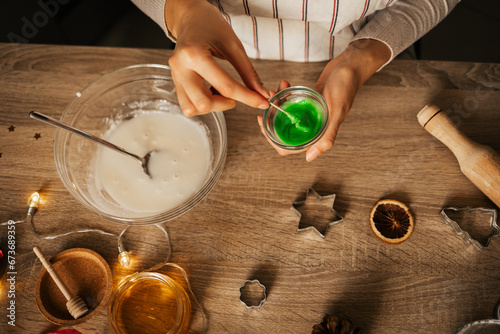 A close-up of the process of making New Year's gingerbread cookies in an atmospheric kitchen at home. Christmas mood. Recipe for New Year's treats