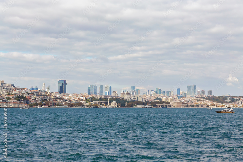 Istanbul panorama as seen from Bosphorus and Kadikoy. Sunny october day, beautiful clouds, Sisli towers at skyline. October 17, 2022 - Istanbul, Turkey