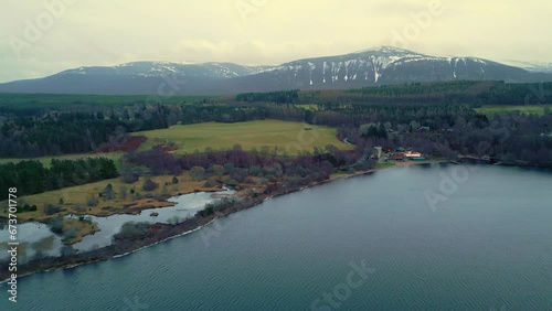 Flying above picturesque Scottish landscape towards a secluded lakeside resort  photo