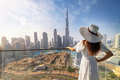 Photography A elegant woman in a white dress looks at the panoramic view of the downtown Bus