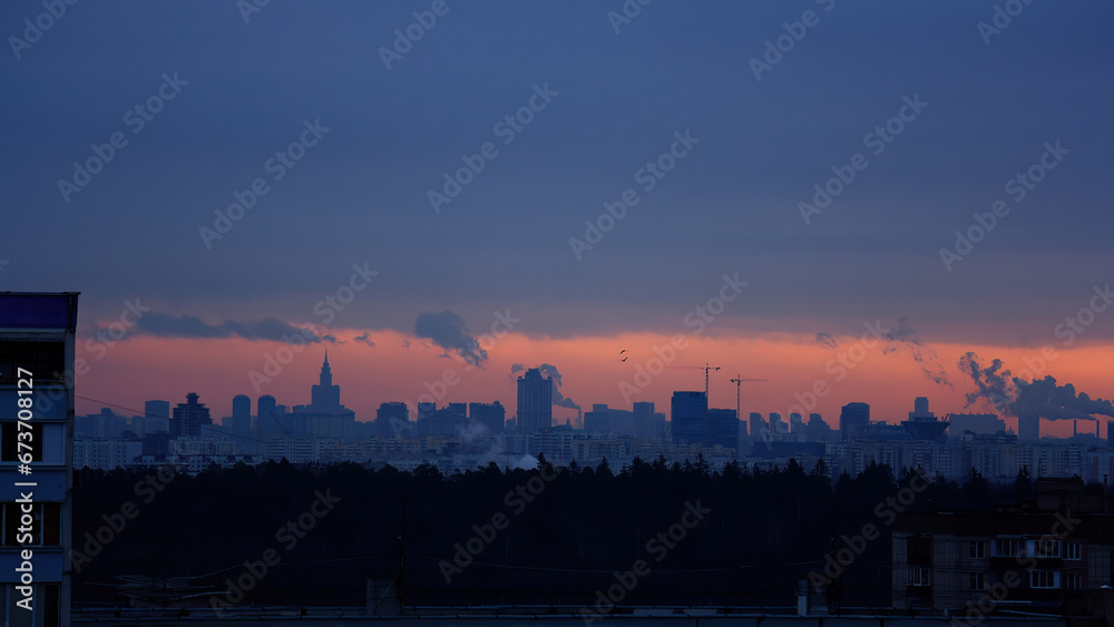 view of city buildings in distance against sky during sunset