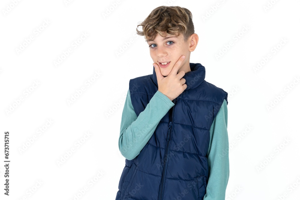 Caucasian teen boy looking confident at the camera smiling with crossed arms and hand raised on chin. Thinking positive. Caucasian teen boy looking confident at the camera smiling with crossed arms and hand raised on chin. Thinking positive.