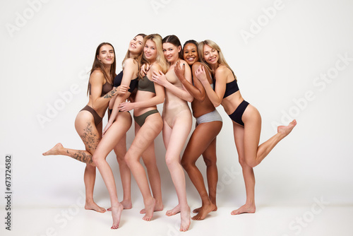 Different skin tones. Mixed female beauty. Young women of different race posing in underwear against white studio background. Concept of multi-ethnic beauty, feminisms, body acceptance, self-care