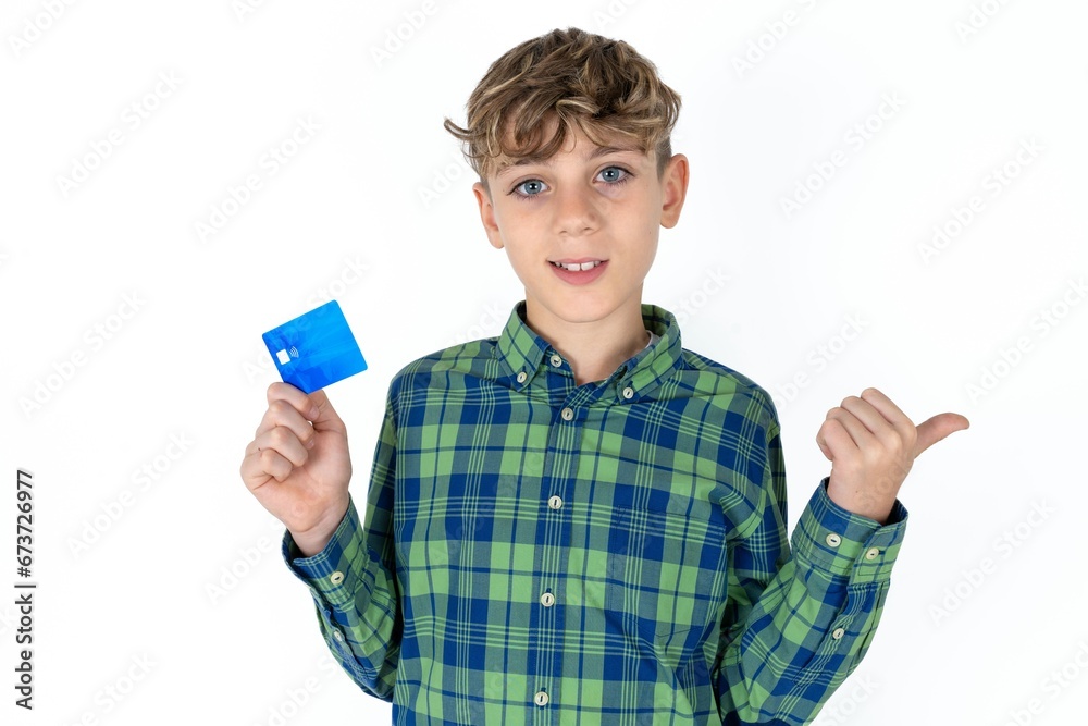 caucasian kid boy wearing plaid shirt hold credit card point empty space caucasian kid boy wearing plaid shirt hold credit card point empty space