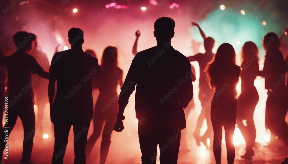 silhouettes of people dancing at a crowded party at midnight, colorful lights and smoke at background silhouettes of people dancing at a crowded party at midnight, colorful lights and smoke at background