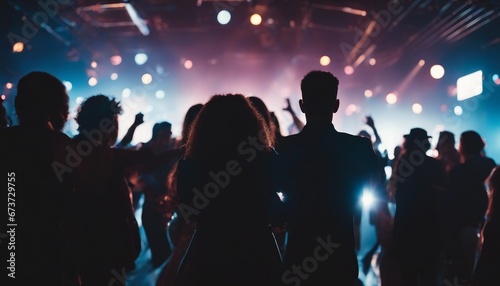 silhouettes of people having fun at a crowded party at midnigh