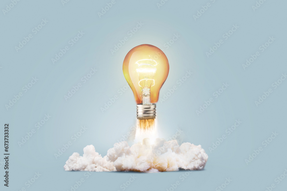 Creative light bulb rocket with blast and smoke takes off on a blue background, concept. Successful launch and development, creative idea. Think differently. Creative generator. Smart and thinking - obrazy, fototapety, plakaty 