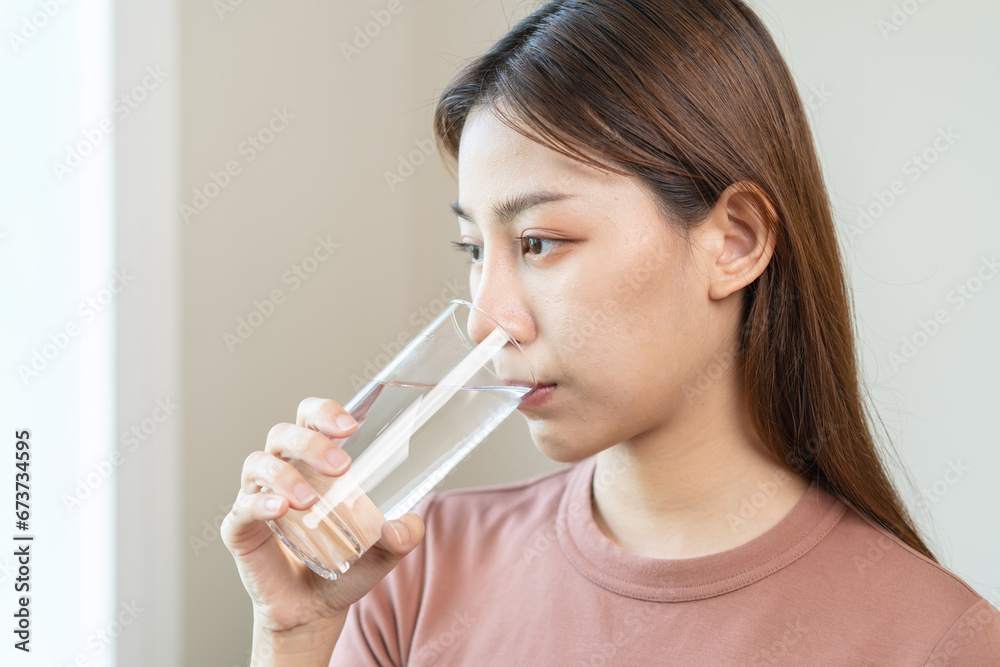 Clean freshwater concept. Woman drink mineral water in the morning for good health. Clean freshwater concept. Woman drink mineral water in the morning for good health.