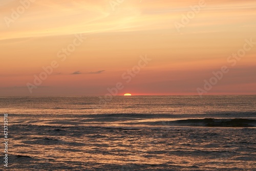 Radiant Sunset Over the Ocean. The Glowing Sun Sinking on the Horizon