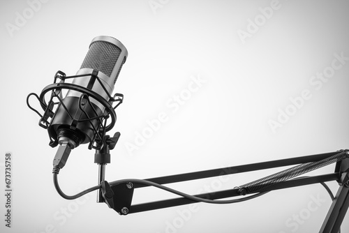 Studio microphone on the mic stand with gray background. Copy space. photo