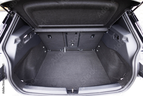 Rear view of the car open trunk. Modern hatchback car with open empty trunk. The car boot is open for luggage. A lot of space for coffers and bags. Ready for a trip.
