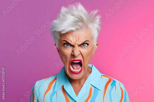 Angry senior Caucasian woman yelling, head and shoulders portrait on pink background. Neural network generated image. Not based on any actual person or scene. photo