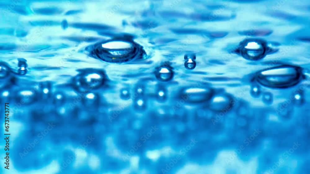 Close-up water bubbling or boiling in clear glass. on a black background.soft focus slow motion. Close-up water bubbling or boiling in clear glass. on a black background.soft focus slow motion.