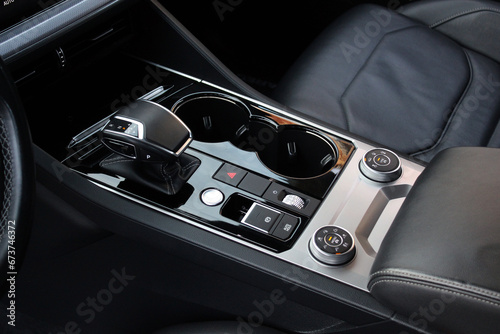 Automatic transmission shift selector in the car interior. Gear lever. Automatic transmission lever shift. Modern car luxury car black leather interior. © Best Auto Photo