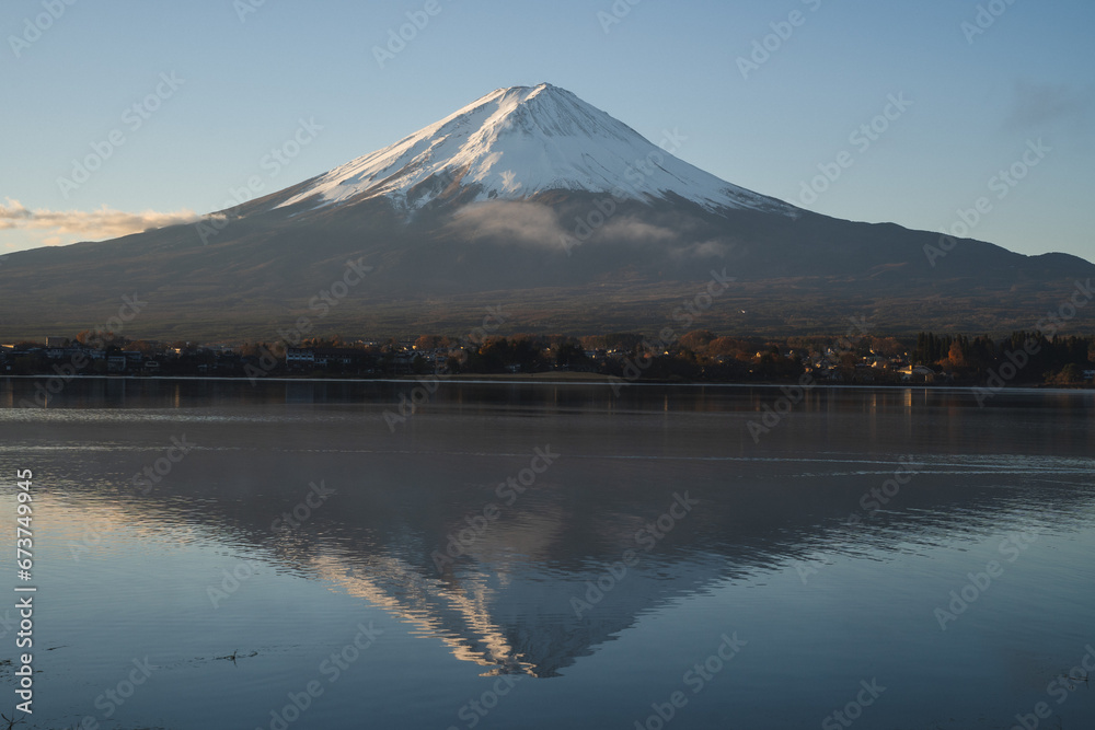 the landscape mountain in Japan fuji mountain reflects the Kawaguchi Lake surrounded by blue sky and snow on the top of the volcano, a beautiful view of the japan volcano on the sightseeing vacation