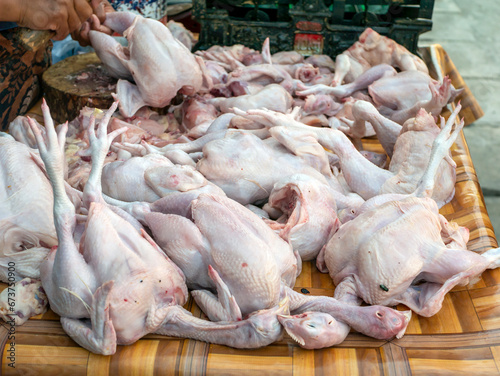 Raw chickens and flies on a plastic carpet, in a traditional market, in Yogyakarta, Indonesia