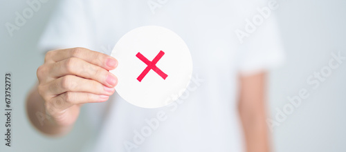 Woman show Wrong symbol paper. True and false, accept and rejected, evaluation, Vote, Poll, Yes or No and Survey concepts