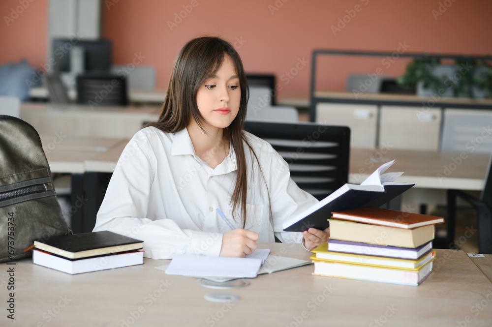 education and school concept - student girl studying and reading book at school. education and school concept - student girl studying and reading book at school.