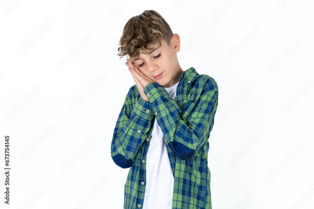 Caucasian teen boy sleeping tired dreaming and posing with hands together while smiling with closed eyes. Caucasian teen boy sleeping tired dreaming and posing with hands together while smiling with closed eyes.