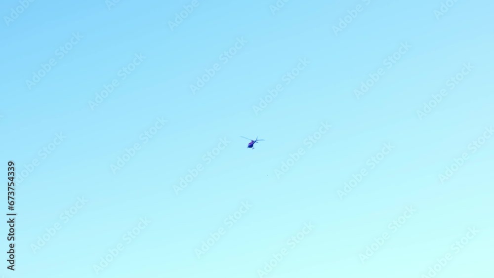 Helicopter Flying Against Blue Clear Sky in a Sunny Day in Switzerland Helicopter Flying Against Blue Clear Sky in a Sunny Day in Switzerland