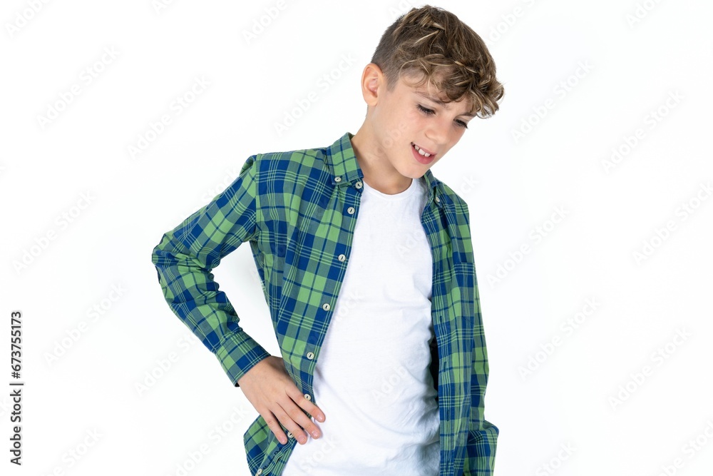 Caucasian teen boy Suffering of backache, touching back with hand, muscular pain Caucasian teen boy Suffering of backache, touching back with hand, muscular pain