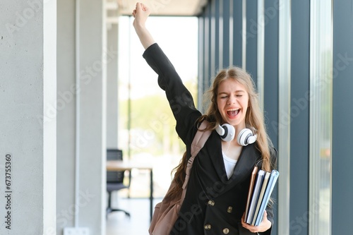 Photography Emotional student girl within walls of institute celebrating successful exam pas