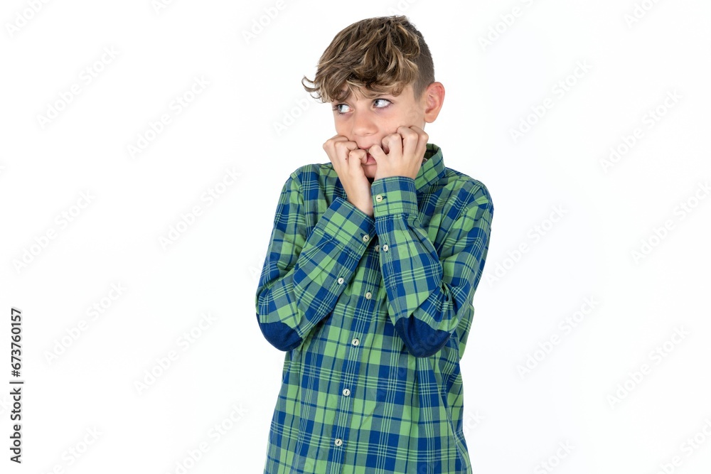 Terrified Caucasian teen boy wearing plaid shirt looks empty space home alone moonless night Terrified Caucasian teen boy wearing plaid shirt looks empty space home alone moonless night
