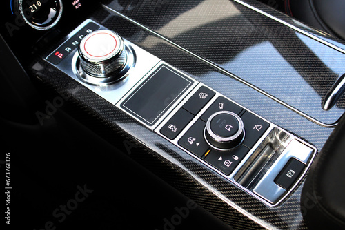 Automatic transmission gearshift stick, SUV air suspension control. Closeup a manual shift of modern car gear shifter. Close up of the automatic gearbox lever, black interior car. photo