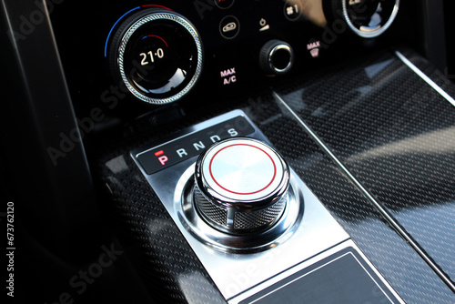 Фотография Close up of the automatic gearbox lever, black interior car, Automatic transmission gearshift stick