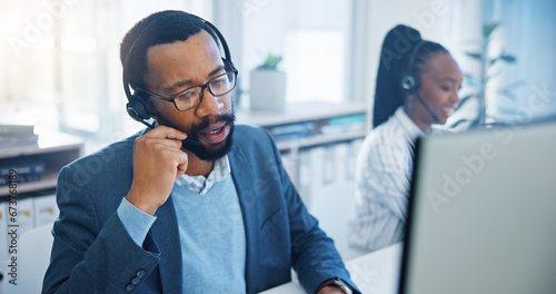 Computer, customer support and a black man consultant working in a call center for service or assistance. Contact, crm and headset communication with an employee consulting in a retail sales office photo