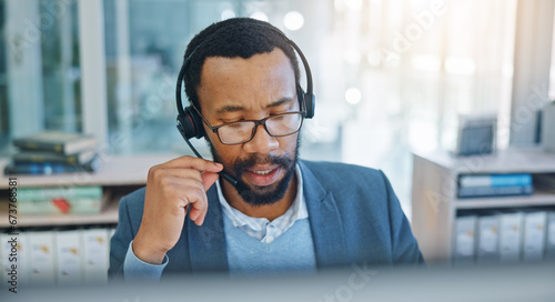 Computer, call center and support with a black man consultant working in customer service for assistance. Contact, crm and headset communication with an employee consulting in an office for sales