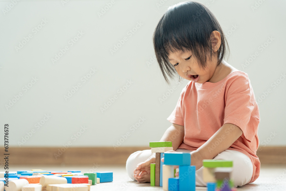 Happy Asian child playing and learning toy blocks. children are very happy and excited at home. child have a great time playing, activities, development, attention deficit hyperactivity disorder Happy Asian child playing and learning toy blocks. children are very happy and excited at home. child have a great time playing, activities, development, attention deficit hyperactivity disorder