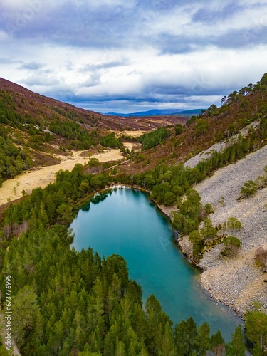 Aerial view of the picturesque Lochan Uaine, surrounded by lush trees in the Scottish Highlands photo