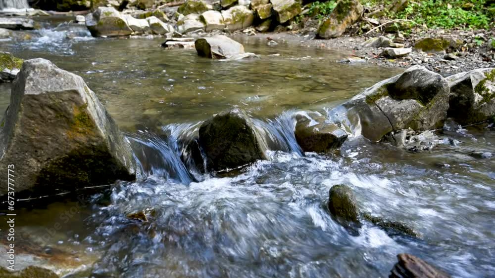 Wild mountain river flowing through stone boulders. Abundant clear stream in carpathians. Wild mountain river flowing through stone boulders. Abundant clear stream in carpathians.