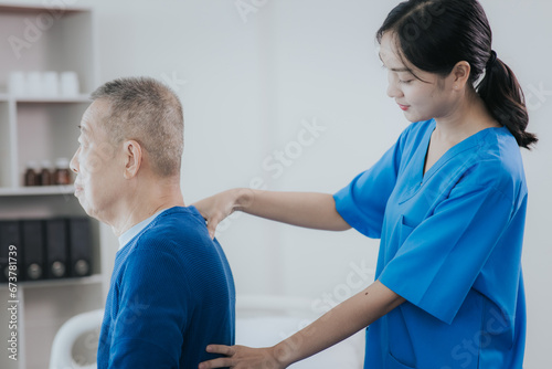 Asian female doctor or nurse exercising with elderly man at hospital