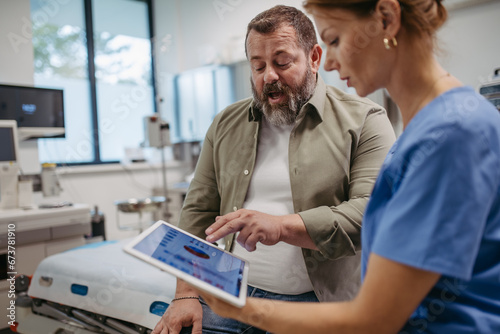 Tableau sur toile Female doctor consulting with overweight patient, discussing test result in doctor office