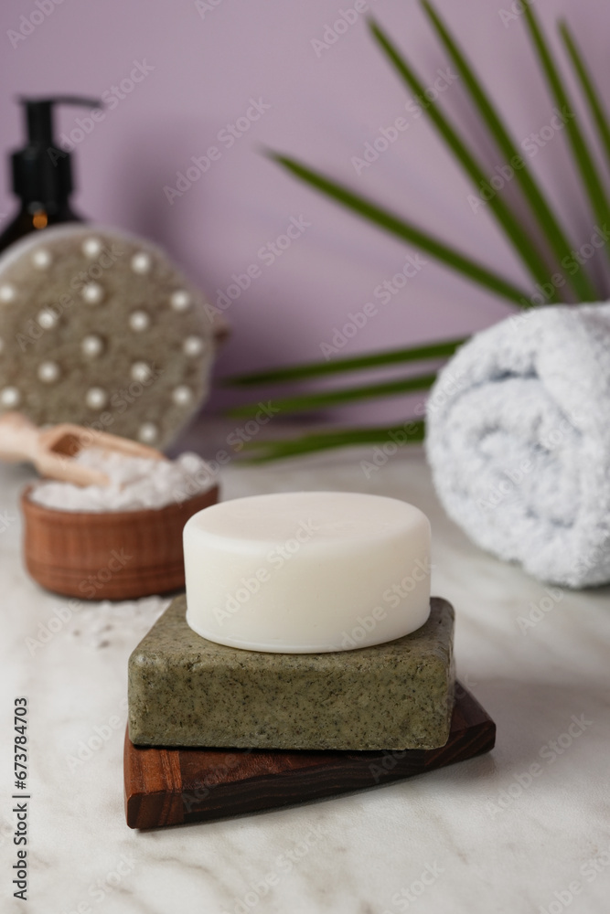 Eco friendly solid shampoo bar and natural bathroom accessories white Bathroom background. Plastic free, zero waste, low water ingredients. Side view. Eco friendly solid shampoo bar and natural bathroom accessories white Bathroom background. Plastic free, zero waste, low water ingredients. Side view.