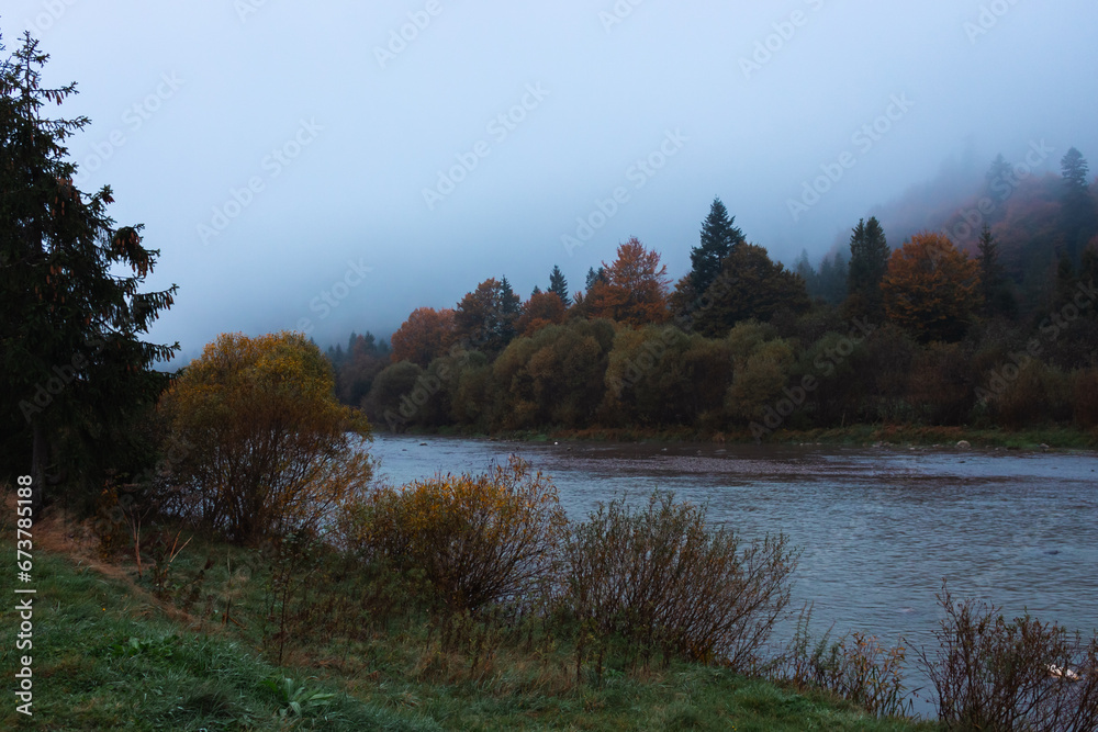 Fog on the river in autumn mountains. Frosty morning in mountains at the riverside. Tranquil autumn landscape with river. Scenic misty countryside. Travel in Carpathian autumn village. Fog on the river in autumn mountains. Frosty morning in mountains at the riverside. Tranquil autumn landscape with river. Scenic misty countryside. Travel in Carpathian autumn village.