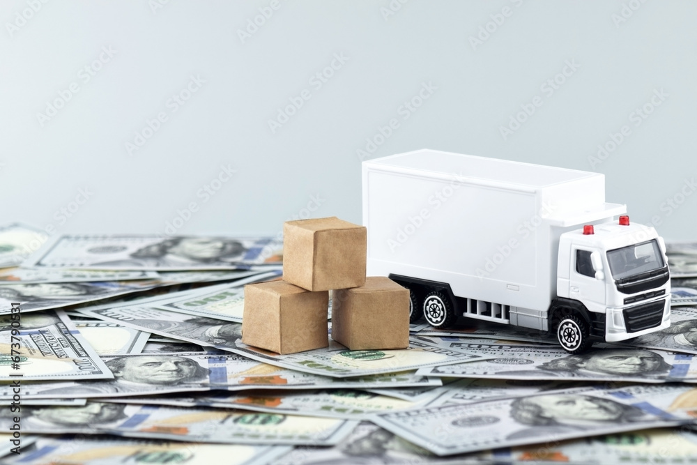 White toy truck with boxes on a light background, space for text. White toy truck with boxes on a light background, space for text.