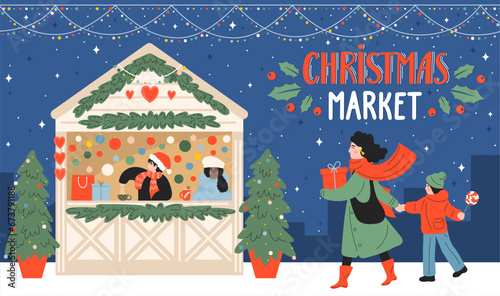 Christmas market. Kiosk of gifts and hot drinks. Woman with child walk and shopping in the evening city with hand lettering.