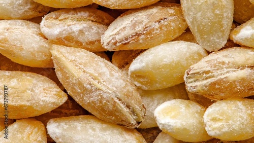 Pearl barley raw spindle-shaped grains, in bulk, moving sideways, close-up macro, top view
 photo