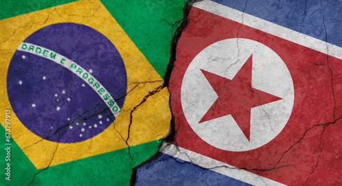 Brazil and North Korea flags, concrete wall texture with cracks, grunge background, military conflict concept