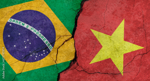 Brazil and Vietnam flags, concrete wall texture with cracks, grunge background, military conflict concept