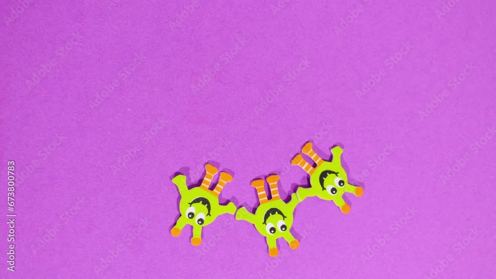 Stop motion animation, funny cartoon characters spin along the time arrow, turning into different characters each time. Concept of change, cycle