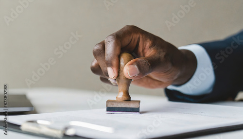 Closed up businessman hand using wooden stamping to document photo