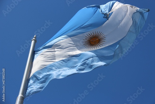 Argentinian flag waving against the background of a blue sky. Plaza de Mayo, Buenos Aires,.