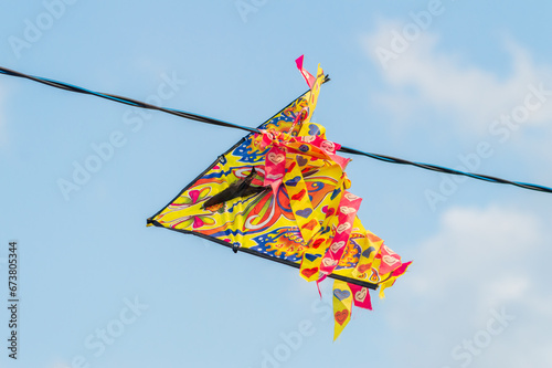 kite gets tangled in wires. the kite is stuck in the electric cable. High quality photo